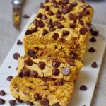 vegan pumpkin bread with chocolate chips on marble board