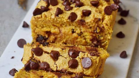 vegan pumpkin bread with chocolate chips on marble board