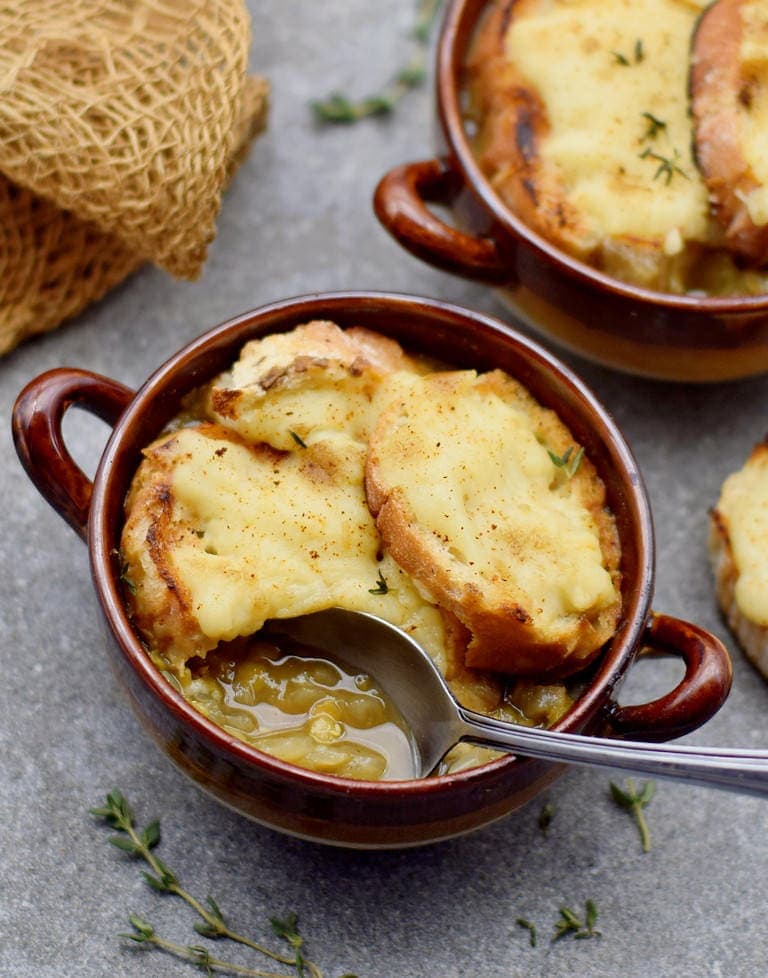 easy vegan French onion soup in a bowl with a spoon