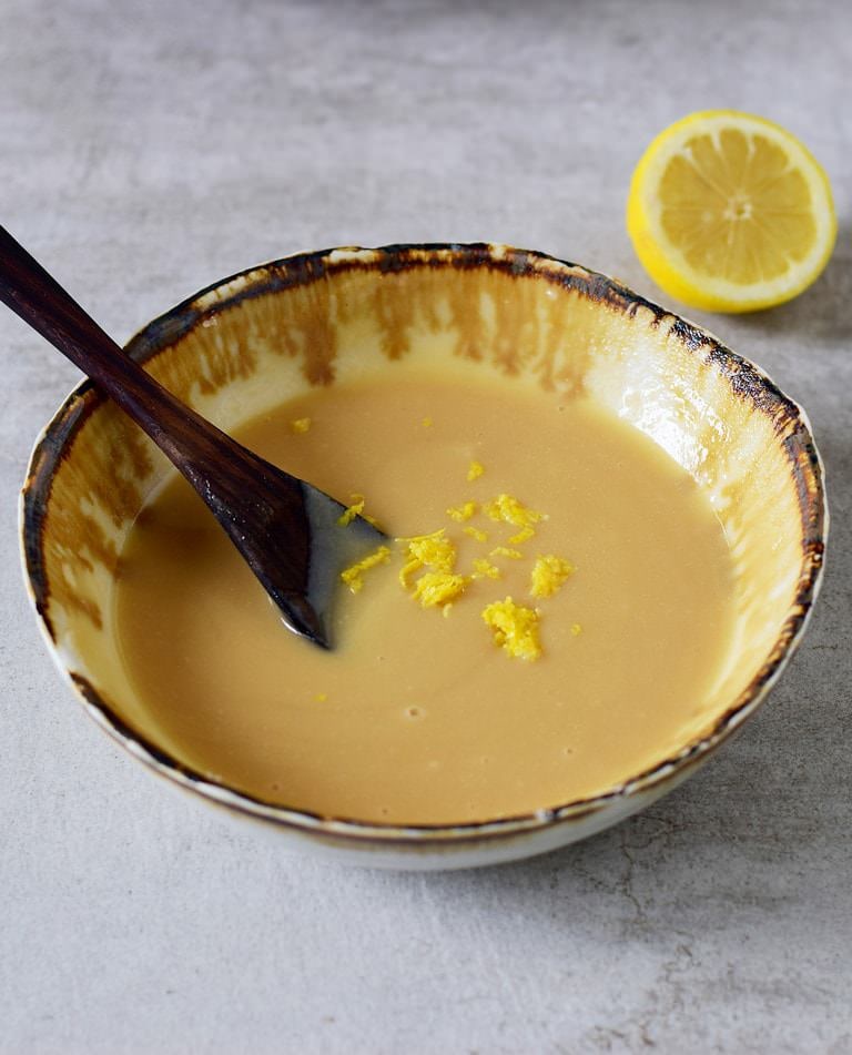 creamy yellow mixture with zest in a bowl