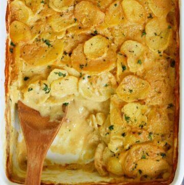 healthy scalloped potatoes with wooden spoon in a baking dish
