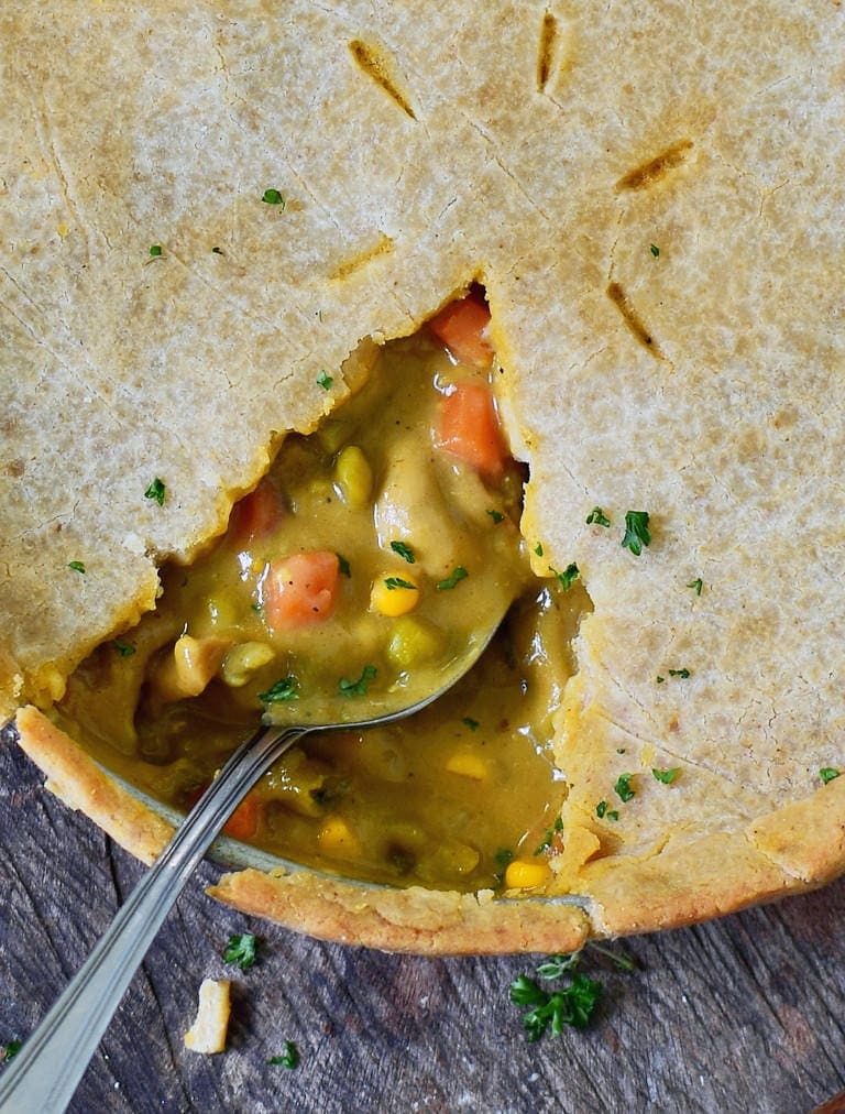 spoon submerged in a vegetable pot pie