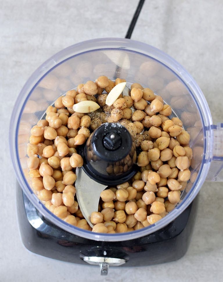 Chickpeas, garlic, and spices in a food processor