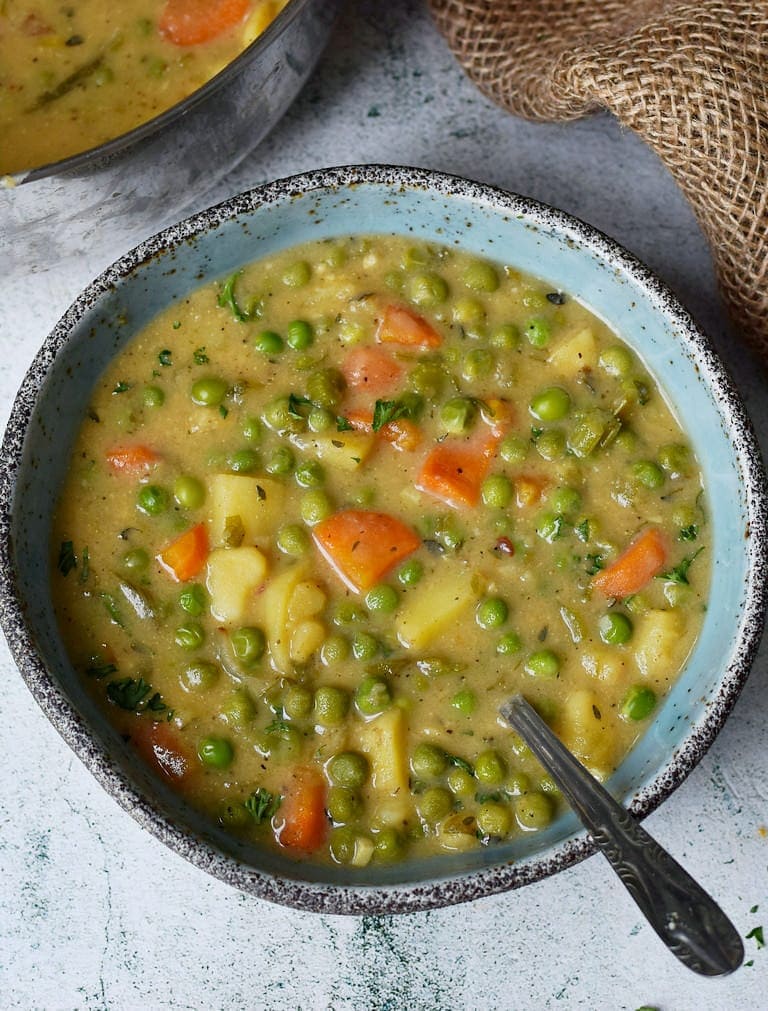 vegan pea soup with vegetables in a bowl