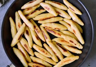 vegan potato noodles in a black skillet