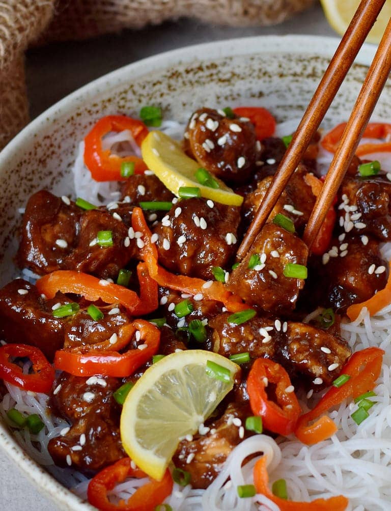 close-up of sticky teriyaki tofu with rice noodles