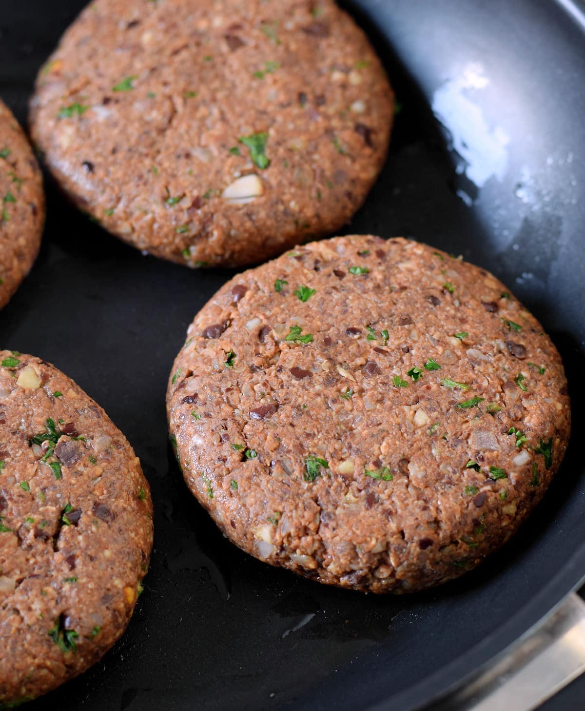 close-up of vegan black bean burgers in a pan