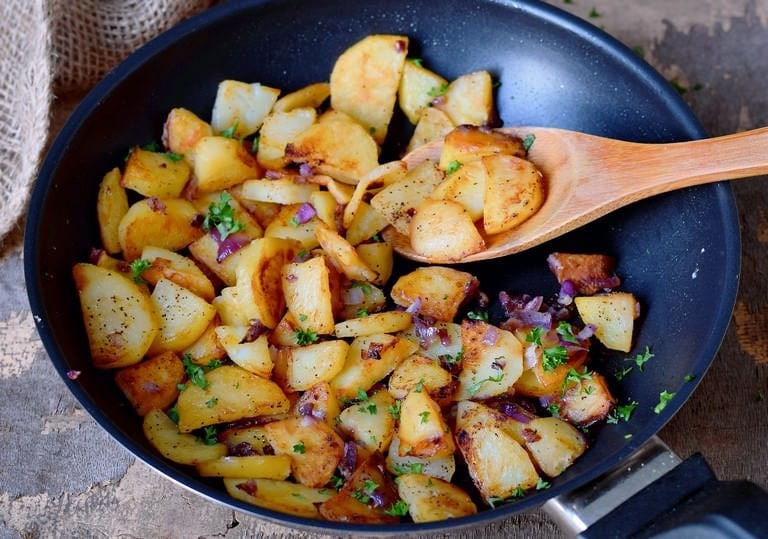 fried potato slices in a skillet