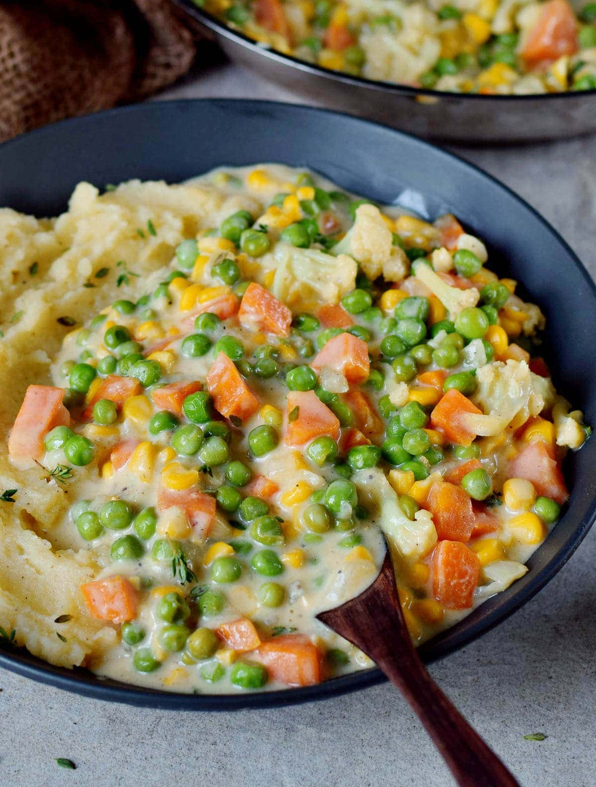 Close-up vegan creamed peas and carrots with mash