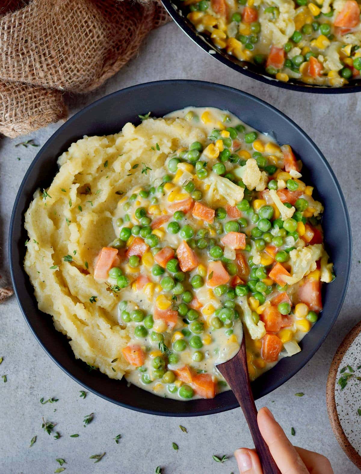 Eating vegan creamed peas and carrots with mash