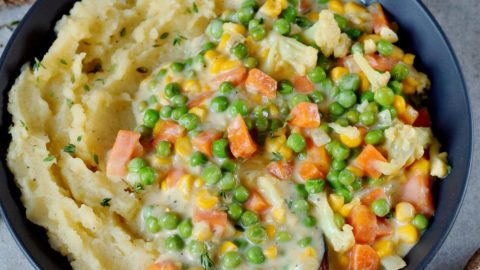Vegan creamed peas and carrots over mashed potatoes