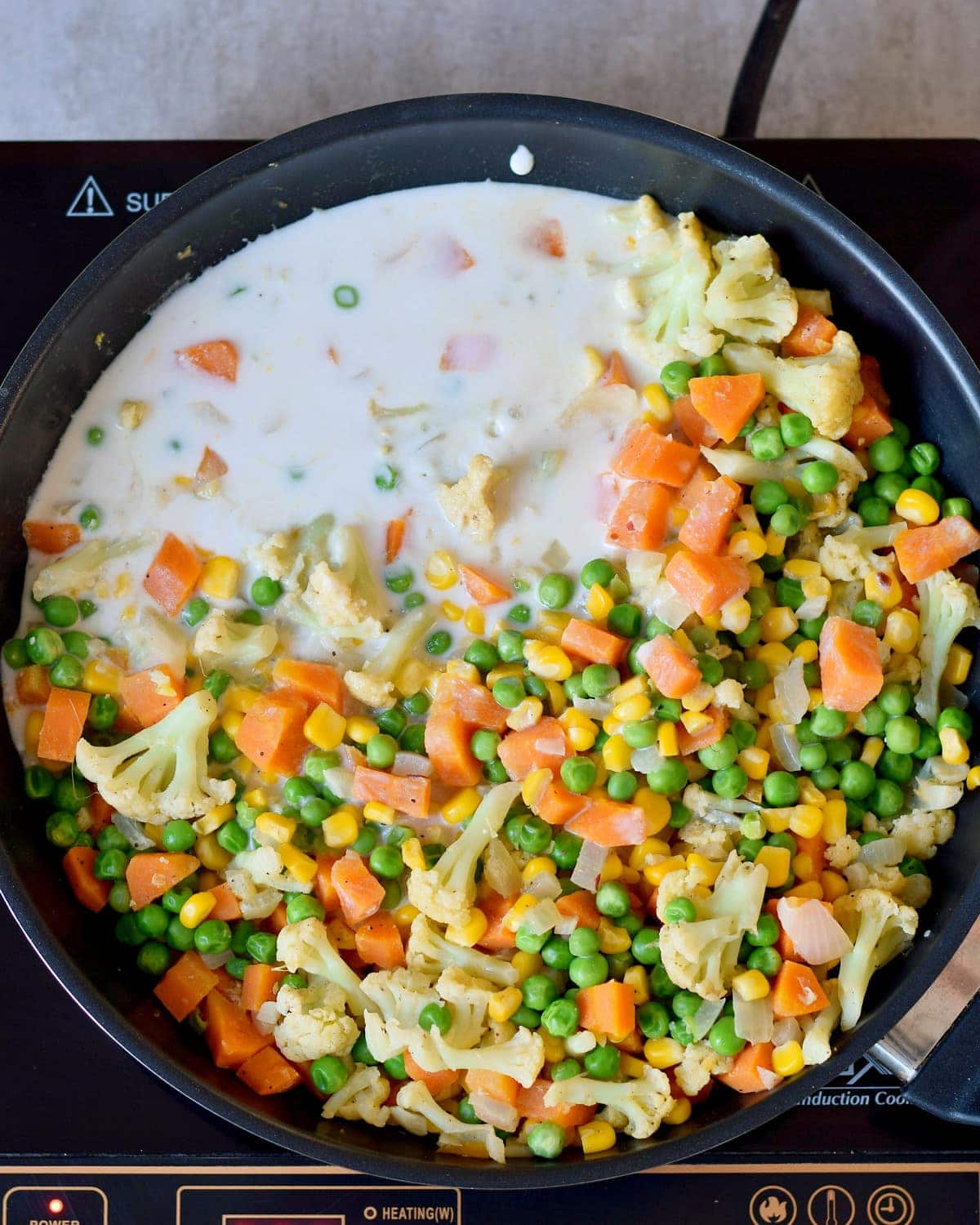 Veggies with plant-based cream in a pan