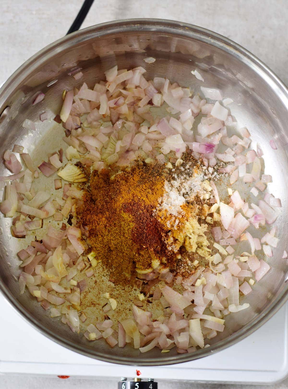 chopped onion garlic and spices in a pot