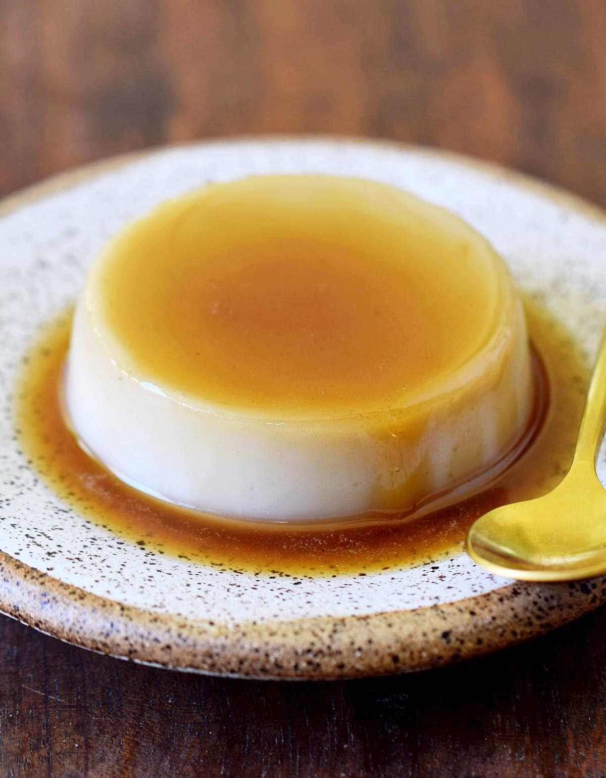 eggless flan on a plate with a spoon