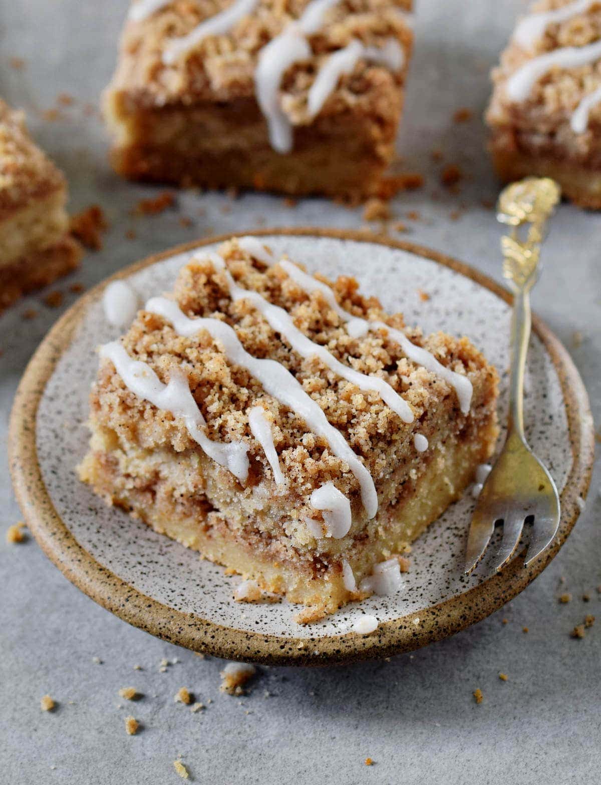 one piece vegan coffee cake with icing on a small plate