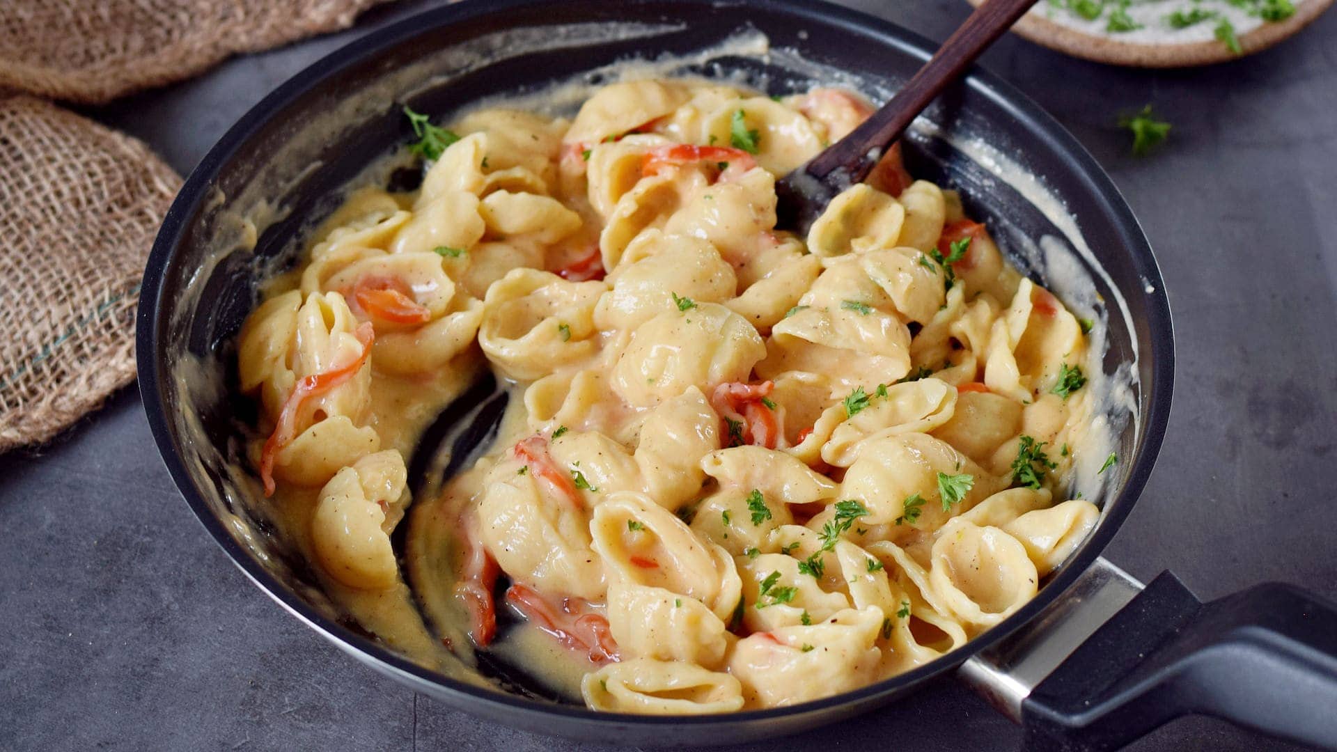 landscape photo of egg-free noodles with garlic butter sauce in a skillet
