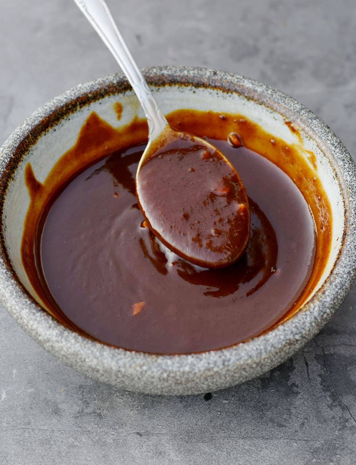 homemade hoisin sauce with a spoon in a bowl