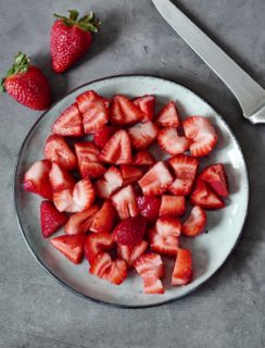strawberries cut in quarters on a plate
