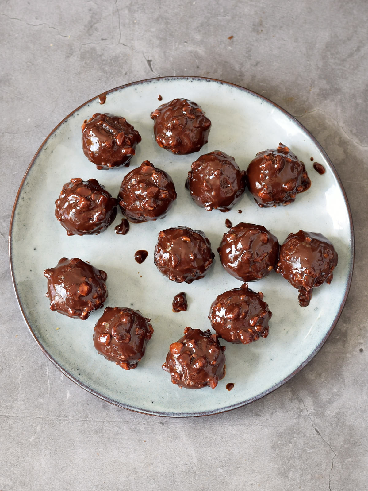 13 hazelnut truffels dipped in chocolate on a plate