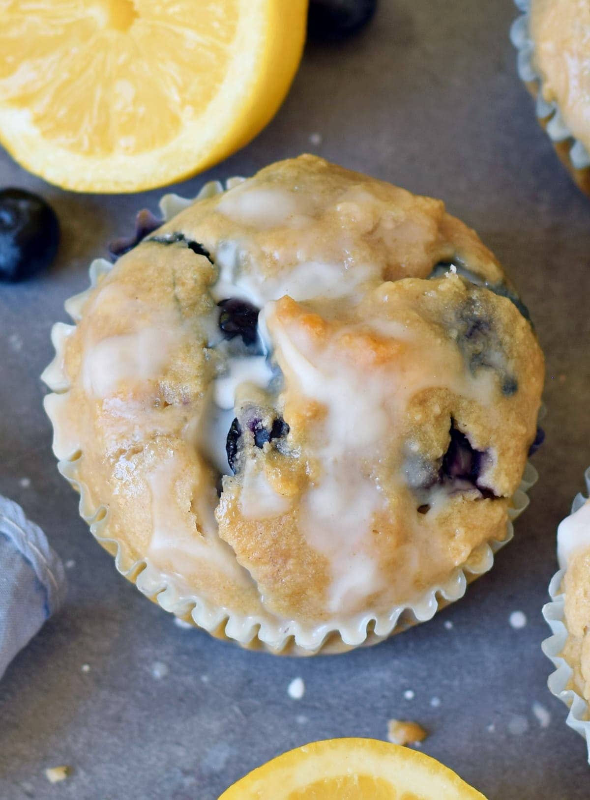 close-up of one lemon muffin with blueberries from above