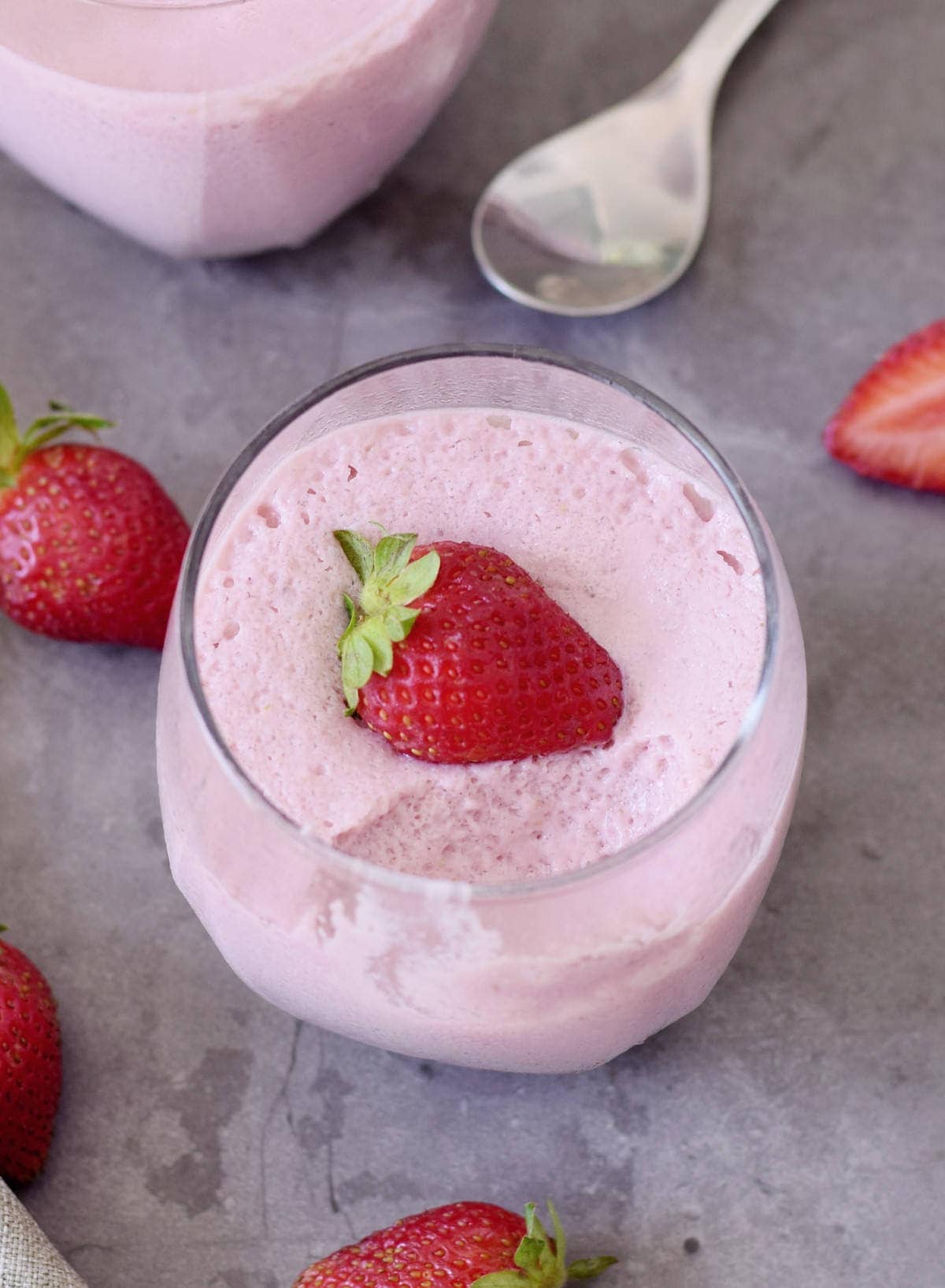 one jar of strawberry mousse with a strawberry on top