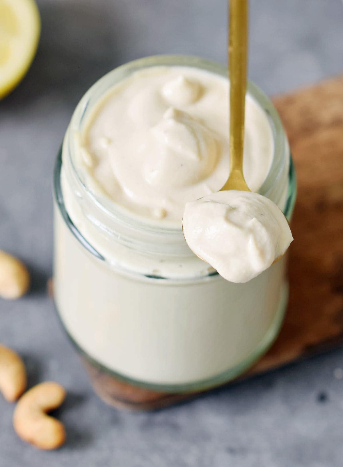spoon on top of a glass jar with vegan creme fraiche
