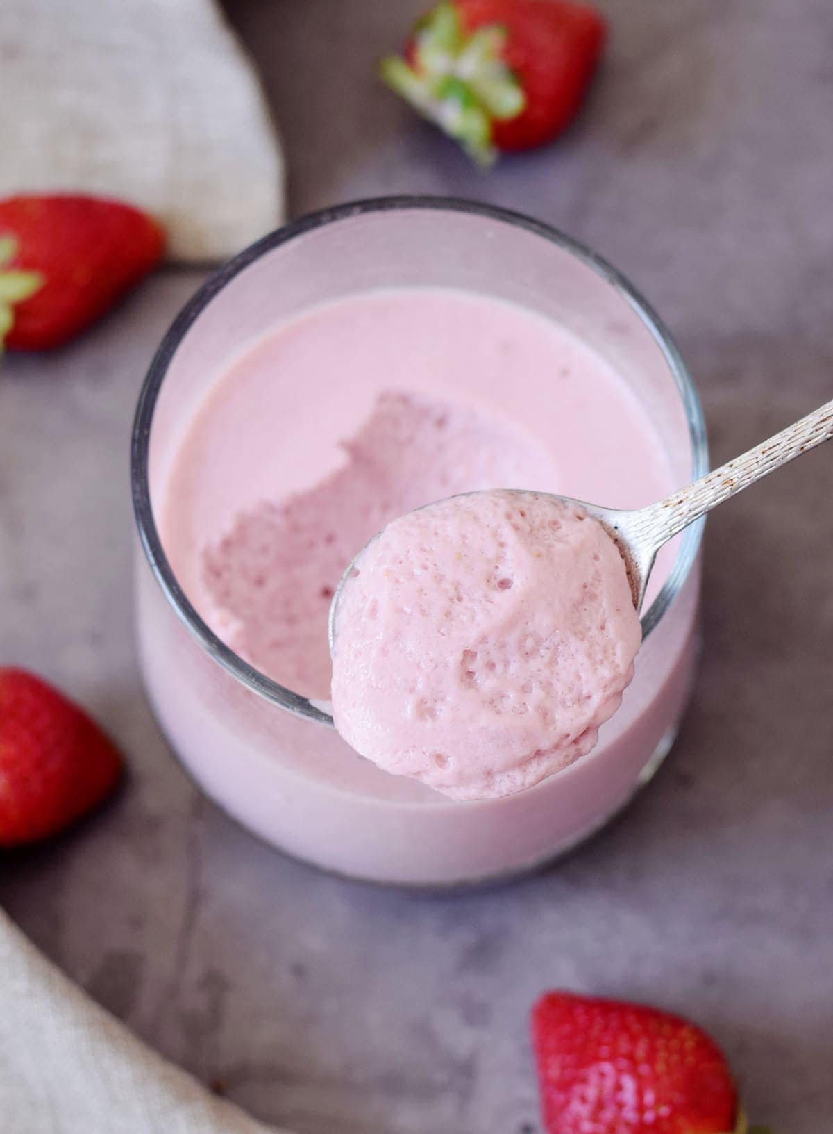 vegan aquafaba mousse with strawberries in a jar with spoon