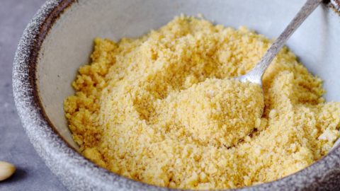 vegan parmesan cheese in a bowl with spoon