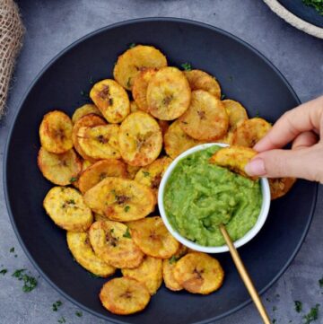 cropped-dipping-a-plantain-chips-into-guacamole-dip.jpg