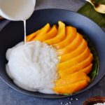 drizzling coconut sauce over mango sticky rice