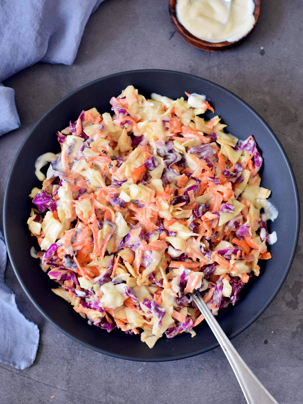 keto cole slaw in a black bowl with a fork