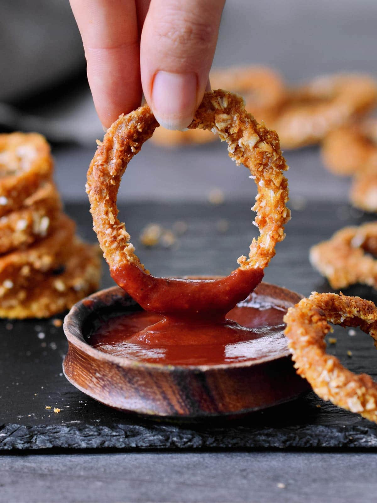 oven baked vegan onion ring dipped in keto bbq sauce
