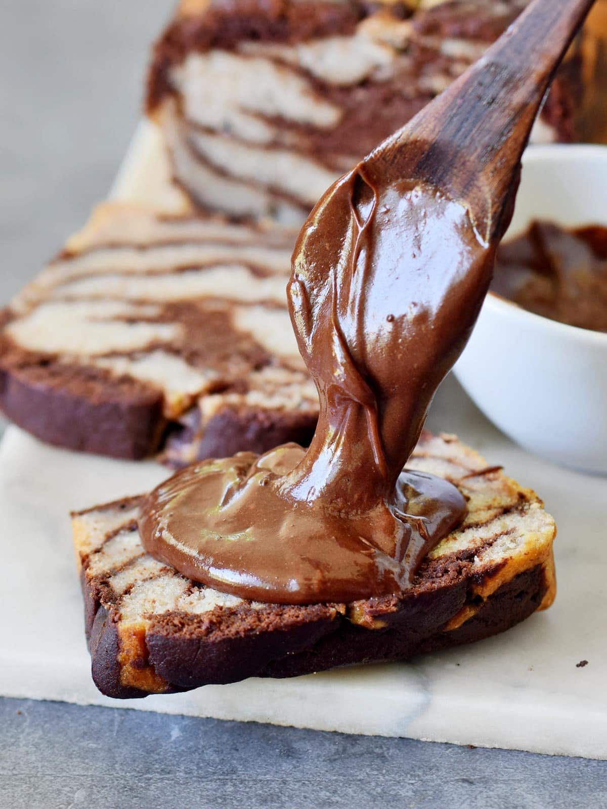 a slice of marbled banana bread with homemade chocolate spread