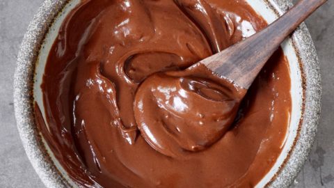 homemade vegan nutella in bowl with wooden spoon