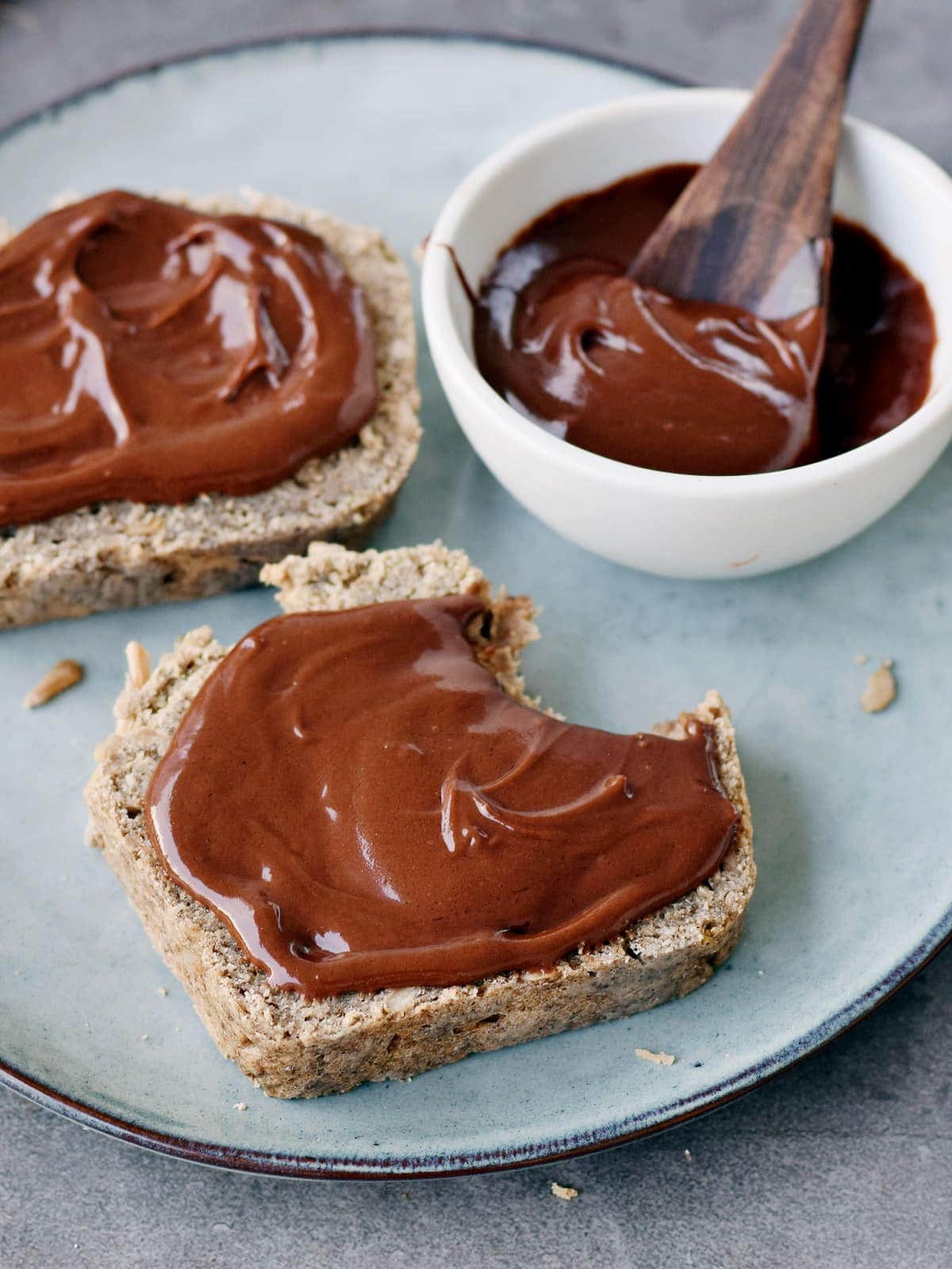 two slices of bread with vegan nutella chocolate spread on a plate