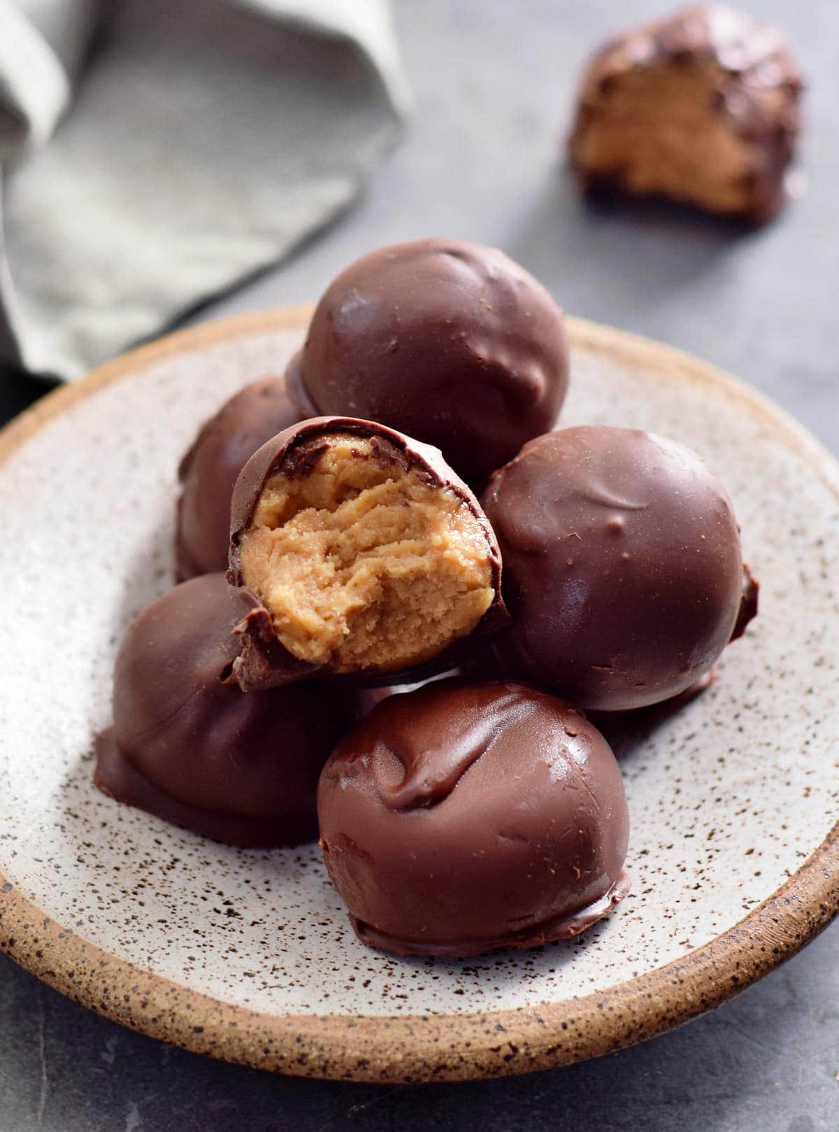 peanut butter candy covered in chocolate on small plate