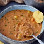 pinto bean soup in bowl with spoon