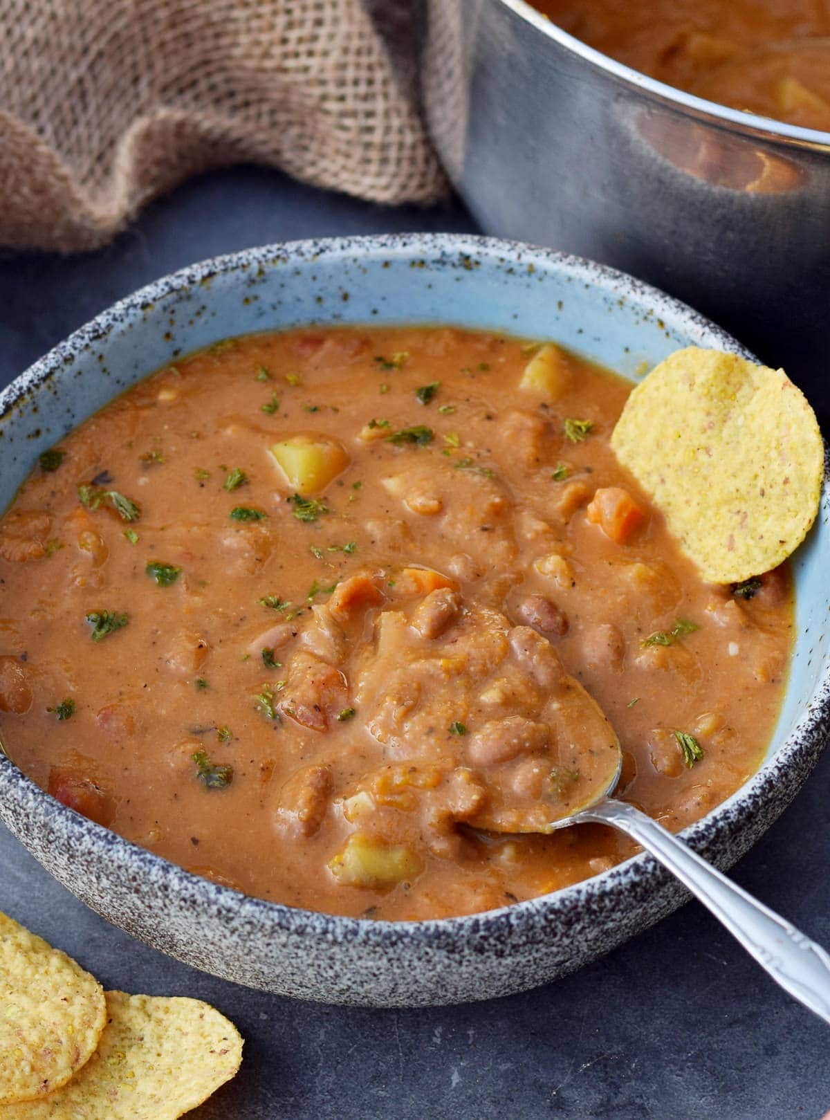 pinto bean soup in bowl with spoon