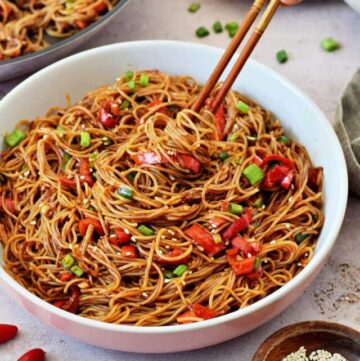 cropped-vegan-spicy-noodles-in-bowl-with-hot-sauce-and-chopsticks.jpg