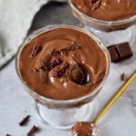 vegan chocolate pudding in 2 jars with chocolate shavings on top