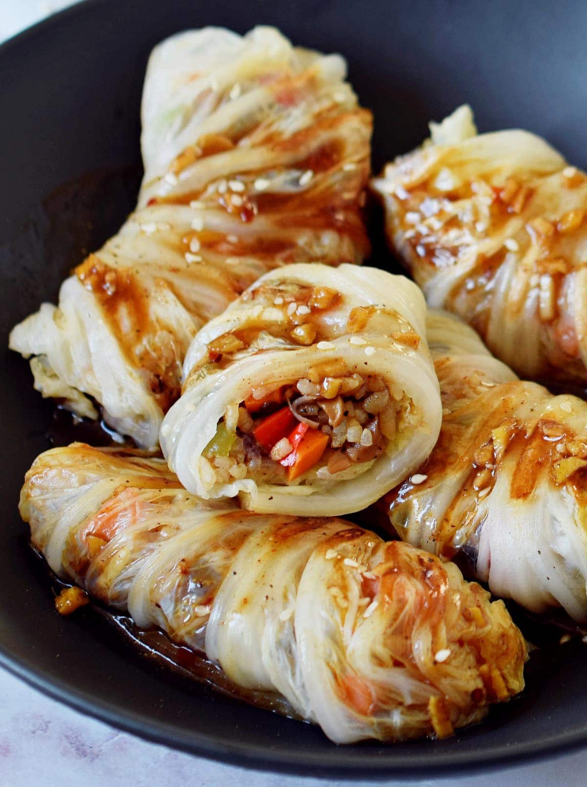 close-up of vegetarian cabbage rolls in black bowl
