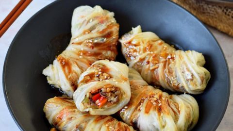 vegan cabbage rolls with brown stir-fry sauce in bowl
