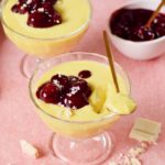 2 jars vegan vanilla pudding with cherry compote and spoon
