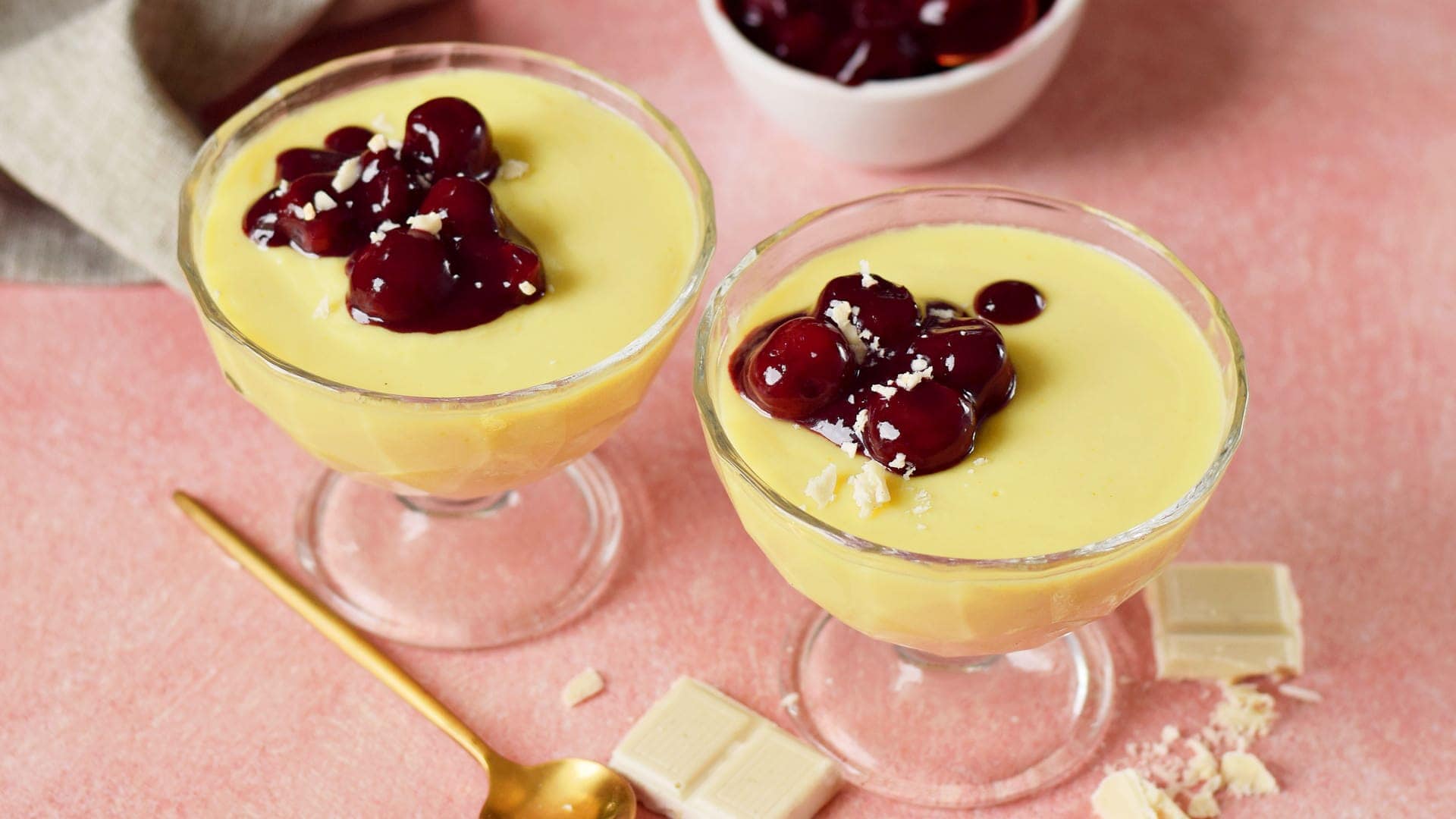 horizontal shot of vanilla pudding with cherry compote