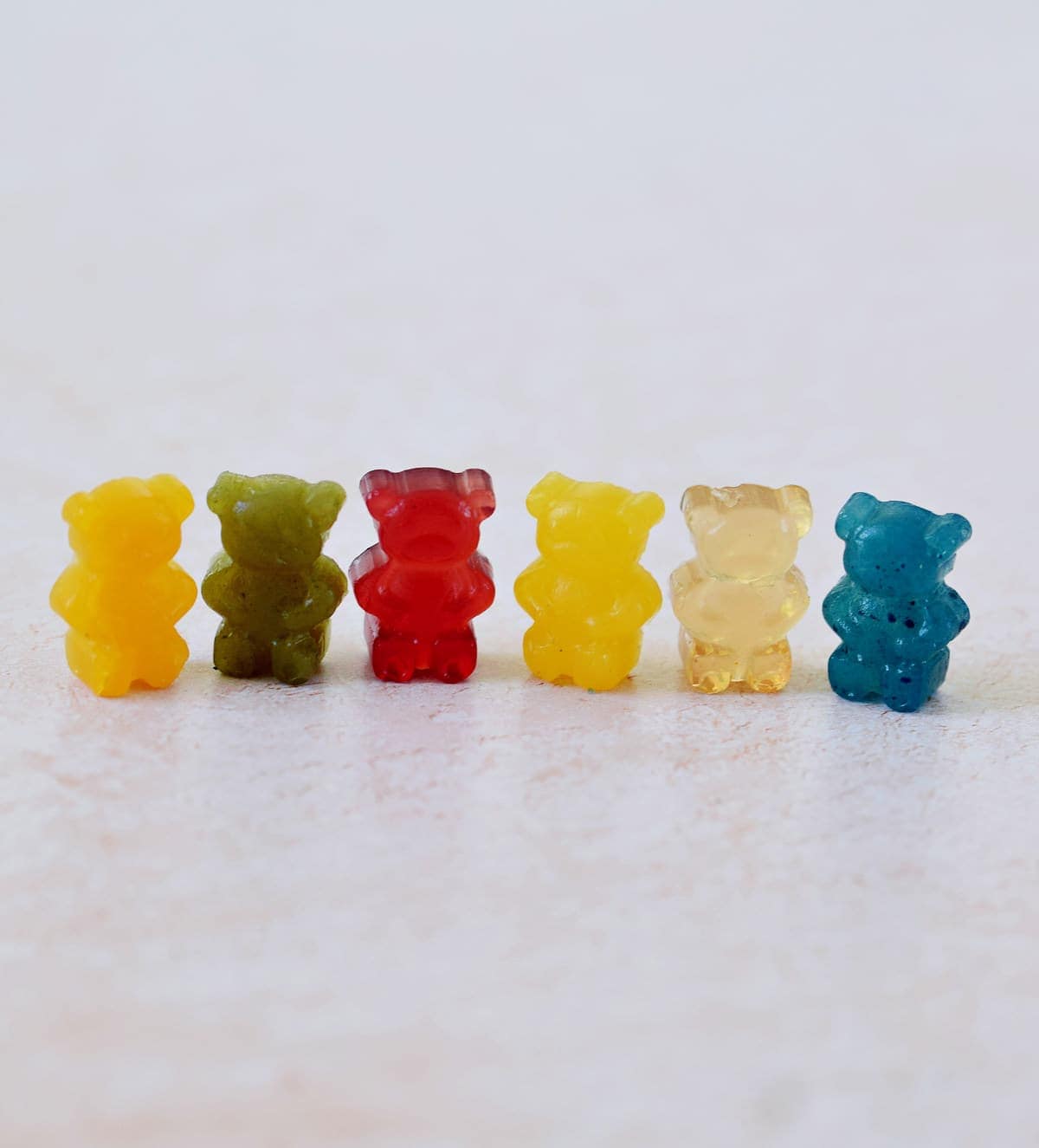 6 vegan gummy bears in different colors in a row