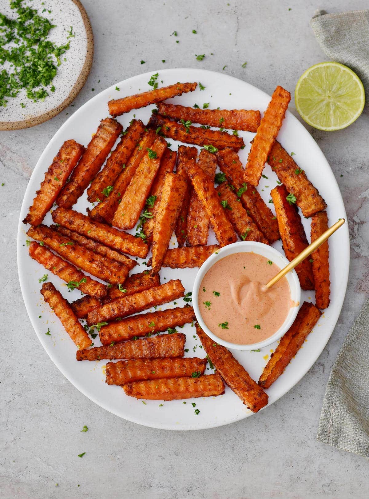 Carrot fries with pink dip on white plate