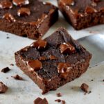 close-up of vegan black bean brownies with melted chocoalte on top