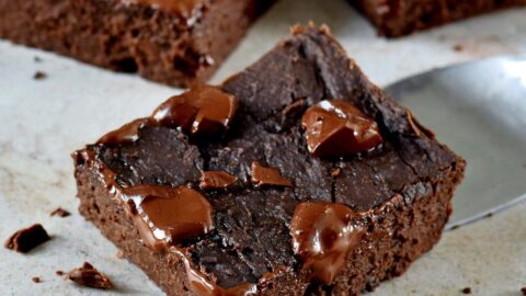 close-up of vegan black bean brownies with melted chocoalte on top