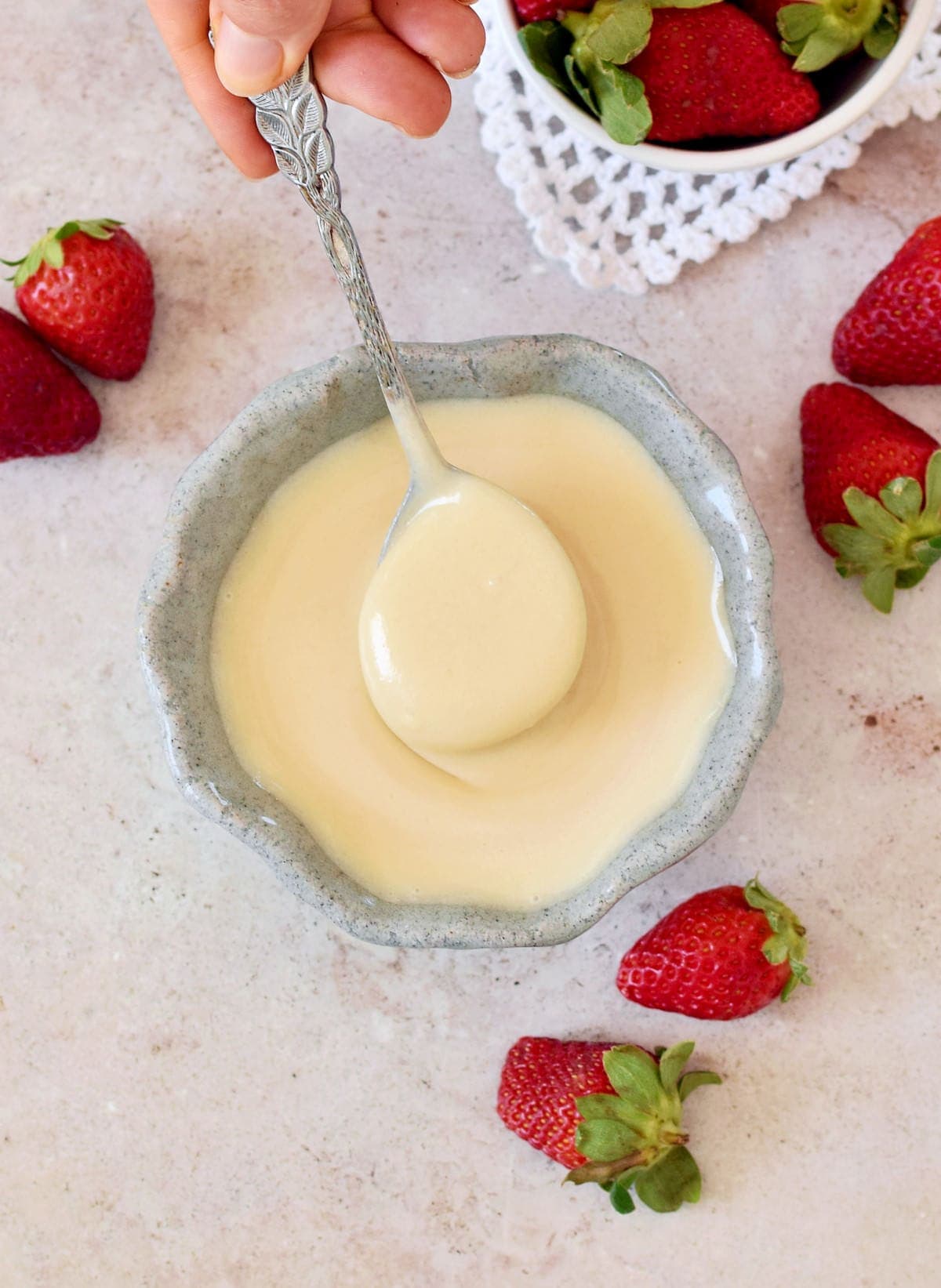 homemade condensed milk in bowl with spoon