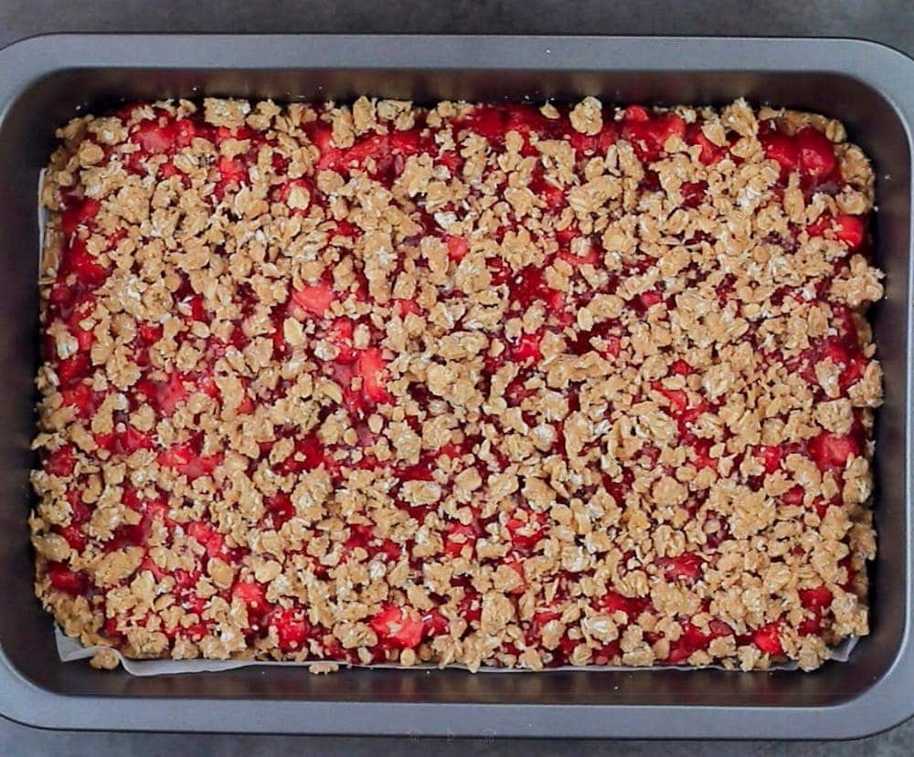 Strawberry crumble cake in pan before baking